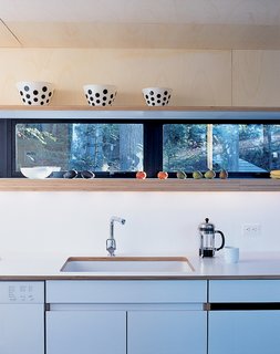 The "bar" area houses all of the service sections like the kitchen, bathrooms, and laundry room.