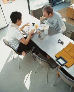 Modern Mixed Use in San Diego - Photo 2 of 11 - At the table, a Todd Oldham for La-Z-Boy modular sofa serves triple duty as seating for work, dinner, and overnight guests.