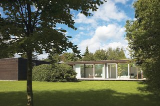 We Summer in the Hamptons - Photo 1 of 6 - The main living space is constructed of immense I-profiles, allowing for a full wall of glass with four large sliding doors that open to the backyard.