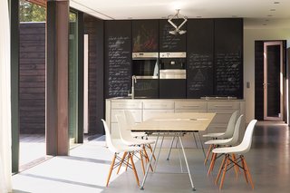 We Summer in the Hamptons - Photo 2 of 6 - Chalkboard-fronted cabinets provide an ideal surface for scrawling shopping lists.
