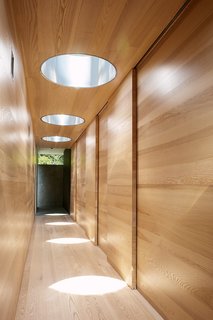 We Summer in the Hamptons - Photo 4 of 6 - In the bedroom wing, sunlight shines down from the Plexiglass bubbles. Steel in the cutaways reflects the light.
