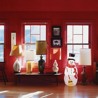 Thrift-store lamps and an illuminated snowman lend the loft a warm glow at night.