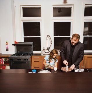 A Minneapolis Building That Has Lived Multiple Lives Is Revitalized by a Coffeehouse Owner - Photo 3 of 10 - Martin and daughter, Eve, whip up a chocolate cake.