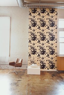 A Minneapolis Building That Has Lived Multiple Lives Is Revitalized by a Coffeehouse Owner - Photo 7 of 10 - In a portion of the living area, a graphic screen print by John Vogt hangs next to a Buttercup Chair by Blu Dot.