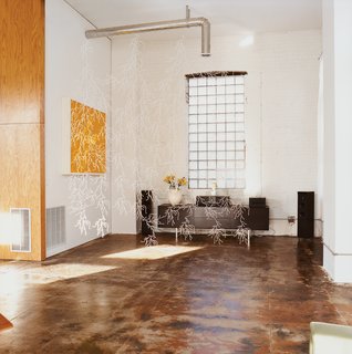 A Minneapolis Building That Has Lived Multiple Lives Is Revitalized by a Coffeehouse Owner - Photo 10 of 10 - White Algue, a web-like plastic hanging element conceived by Ronan & Erwan Bouroullec, breaks up the living space without taking away from the open feel of the room, while idiosyncrasies like exposed piping and polished cement floors add texture.