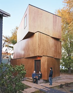 Schenk, Kim, and Peeradorn Kaewlai (their friend and tenant) outside X-Small, the final piece of Schenk and Kim’s design puzzle, and hopefully their new home. Windows are strategically placed to maximize light and privacy.