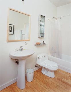 The family opted for modest—and cheap—design choices in the kitchen and bathroom (above), which are commonly the most money-sucking rooms in a home.