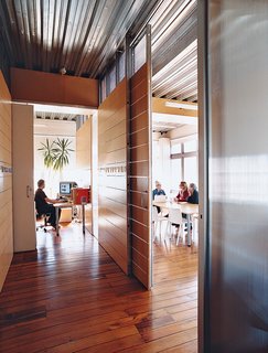 A view of the building’s third-floor offices, formerly the Bieringas’ loft. The floors date from the building’s days as a clothing factory. "When we first moved in, I spent hours on my hands and knees pulling out carpet nails and sewing needles from the wooden floorboards," Luit says. Now the space houses the Bieringas’ offices, plus those of other creative industries.