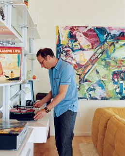 Community Building - Photo 2 of 10 - Randy Rapaport can’t get enough of his favorite band, the Flaming Lips, and happily whiles away the hours spinning their records in his 1,000-square-foot loft. On the wall is a painting by Timothy Scott Dalbow that Rapaport picked up from the nearby New American Art Union Gallery.