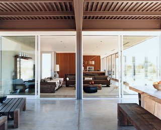 Desert Utopia - Photo 8 of 9 - There are generously proportioned nine-foot-high ceilings throughout the Desert House. Marmol Radziner designed and built the outdoor table and benches from reclaimed Douglas fir.