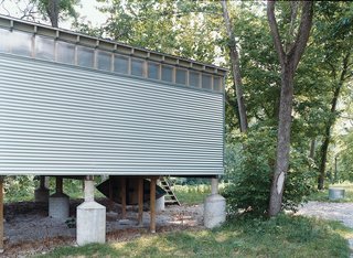 This prototype of a prefabricated home rests on oversized flood-rated pylons and was designed by Missouri-based architect Rocio Romero.