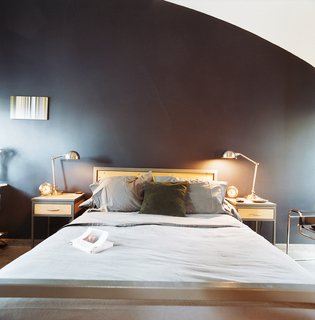 The architects designed the bed and nightstands themselves and picked up the lamps from Target. "We've found that you can mix design and commodity stuff well if you're attentive to the overall presentation," says Schatz.