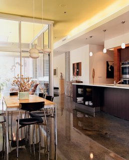The interior of developer Chris Sally's unit was also designed by El Dorado. The table is a hand-me-down from Sally’s parents, but the Marre Moerel light fixture is not. Sally’s fiancée, Julie Gibson, had doubts about the trademark Eldo Green they decided to paint the unit’s ceiling.