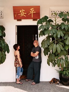 Ian and Yeo’s house was uninhabitable when they purchased it in 2002. Three months later, the roof caved in. The translation of the sign above the door of the couple’s renovated house is "peace."