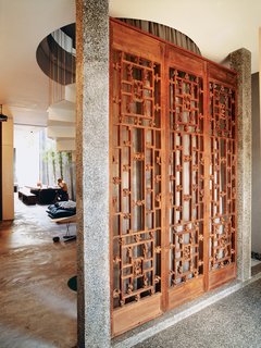 Once inside, visitors are greeted by three ten-foot-tall hand-carved antique panel doors.