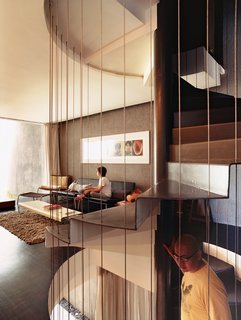 Behind an unassuming 19th-century facade in Singapore's Joo Chiat neighborhood, Ching Ian and Yang Yeo's renovation of a typical shophouse venerates tradition while looking squarely to the future. Yeo descends the spiral staircase that connects the public and private spaces while Ian relaxes on a pair of Cappellini Superlight 750 sofas designed by Barber Osgerby. 