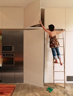 The kitchen was custom made by a local carpenter due to its unconventional scale. The appliances consist of a De Dietrich oven, Amana refrigerator, and Imperial microwave.