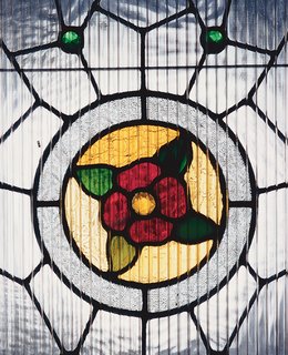 Although his designer friends give him a hard time about it, White decided to keep the original home’s stained glass by the entry.
