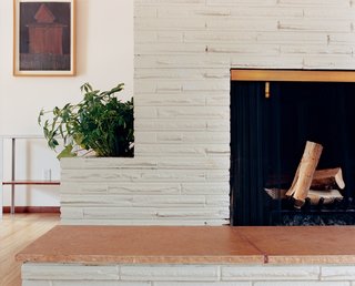 White was charmed by the original fireplace with a built-in planter—so much so that the new open floor plan is centered around it.
