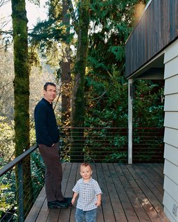 Brian and Markus are pictured here on the ground-floor deck. New stairs lead down to the basement level and garden.