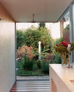 Venetian Vicissitude - Photo 6 of 9 - Only glass separates Farmer and Kozely from their backyard (and Celtic cross reproduction) when they shower. The shower floor is ipe wood; the walls are covered in one-inch-square travertine mosaics.