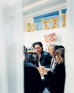 Marcel Wanders - Photo 11 of 11 - This page: Every day, Wanders eats lunch with his team of 12 in the studio, watched by an array of One Minutes that look like a row of angels or winged victories. The red-and-white Op Art–inspired lamp shade was designed for One Minute, which is usually used as a lamp stand.