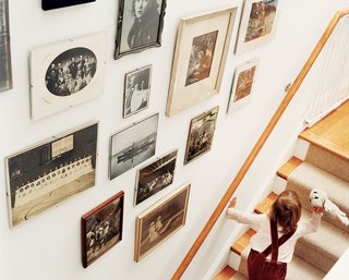 Row House Revival - Photo 7 of 8 - "You have all this history underneath you here," says Matthew Bardin. A display of evocative old family photos, arranged in the stairwell, underscores Bardin’s point.