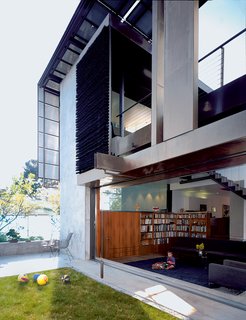 Solar Inspiration - Photo 5 of 8 - In Scarpa and Brook' own house, they’ve mounted luminous solar panels in a rusted-steel-beam grid to form a modernist canopy that frames the façade. This imaginative "solar umbrella" hides the household power plant in plain sight, part of an artful composition that includes a hanging screen tied with bristles of industrial brooms.