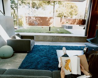 Solar Inspiration - Photo 1 of 8 - The living room flows effortlessly out to the courtyard. This unity is underscored by the living room’s blue shag rug from the Shag Rug Company.