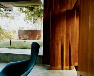 Solar Inspiration - Photo 7 of 8 - The fluted cherry front door, designed by Scarpa, launches a rippling motif that reappears in furniture and on walls. The Harry Bertoia Bird chair is from Knoll.