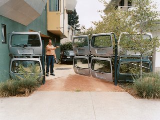 Karl Wanaselja, with clicker in hand, redefines "gated community." Acting as the contractor, he worked closely with a gate fabricator to assemble the unusual entrance. "I wanted to find an orange one," he says, referring to the Volvo hatches, "but finding seven silver ones was hard enough."