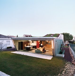 Suburban House of the Future by Cloud9 - Photo 3 of 10 - The rear of the Villa Bio features an almost 50-foot-wide expanse of glass.The pool (now just a large gravel pit) echoes the panoramic window’s exact shape. The custom kitchen features a Silestone counter.