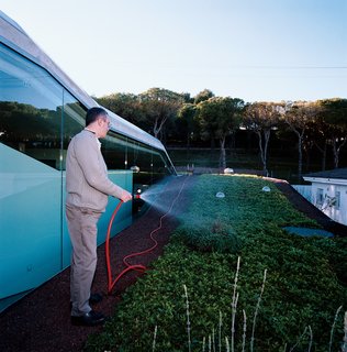 Suburban House of the Future by Cloud9 - Photo 4 of 10 - Owner Carles Fontecha waters his rooftop garden.