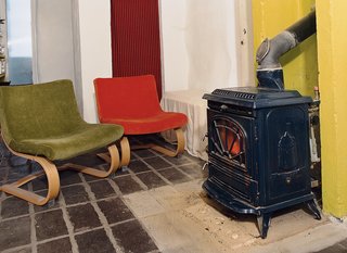 Emerald in the Rough - Photo 8 of 10 - IKEA chairs rest next to the woodstove.