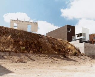 From the rear of the Gracia house, the city’s still rough character comes through.