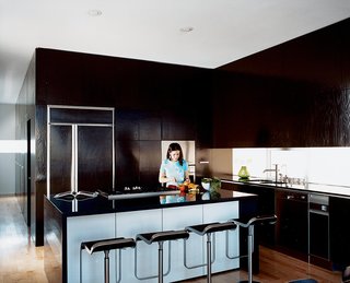 In the kitchen, Jorge worked with local cabinet makers, Muebles Finos JV, to create ample storage, leaving countertops uncluttered. The LEM Piston Stools are by Shin and Tomoko Azumi.