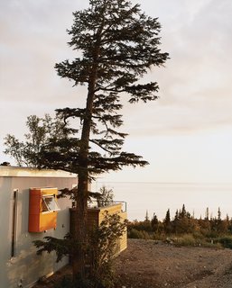 Laid out in a 270-degree panorama in front of the house is the frosty expanse of Cook Inlet, cascading rocky mountains, and a white sun as big as a dinner plate.