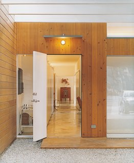 Bringing Families Back to Downtown Dallas - Photo 3 of 9 - The backlighting Baum included above the storage units lining the hall is revealed at dusk. The lighting provides a warm glow throughout the house.
