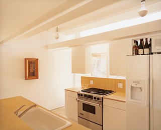 Bringing Families Back to Downtown Dallas - Photo 8 of 9 - The kitchen is lit with plenty of natural light from the open-air carport directly in front of it. All appliances and cabinetry are off the shelf from various big-box stores.