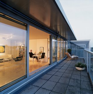 Wall-to-ceiling glass panels on the two exterior walls maximize the views and flood the apartment with light. The interior wall panels can be entirely removed to create a single loft space.