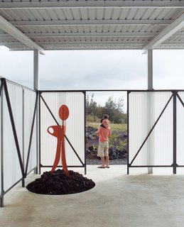 The screen around the lanai is made from extrene, a material used by the military for radio towers. The welded-steel sculpture, set atop a pile of a’a rocks, was made by Craig.