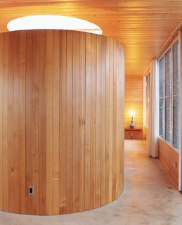 The tub room sits at the end of the hallway leading to the bedroom, and serves as a visual centerpiece from almost every area of the home. The steel frame bisects the opening for the six-foot-wide skylight.
