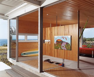 A small room divider offers a place to hang Cathy’s painting Pelevision, which was inspired by her first trip to the island.