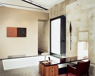 In the entryway, what at first appears to be a rug is actually cut blue glass terazzo designed by Marwan Al-Sayed.