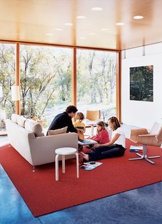 Having lived, he says, in "a number of houses where the living room is the most adorned and the least used," it was important for Lazor to create a functional family living space. As the gathering above attests, it worked. The carpet is by InterfaceFLOR, and the armchairs by Blu Dot.