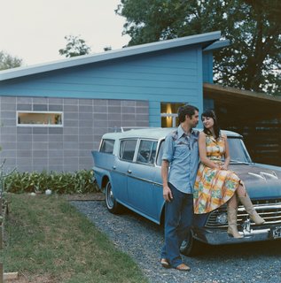 Andy and Regina Rihn lean on their other blue-clad affordable design, a 1958 AMC Rambler Super station wagon, in front of their house in Austin, Texas.