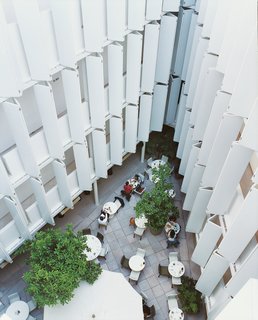 The patio café at Condesa df is framed by the hotel’s unique sliding balcony shades.
