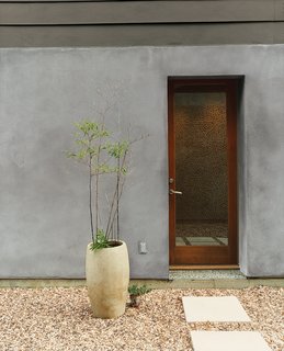 Houston, We've Solved a Problem - Photo 2 of 8 - Designers Matt and Tina Ford created the concrete planters that dot the gravel courtyard. 