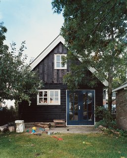 The back entrance to Jongstra’s office is oufitted with a sandbox and littered with her sons’ toys.