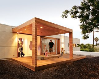 Building Green in Santa Monica - Photo 2 of 5 - Thorsteinsson (above left, standing in doorway) relaxes with his daughter Carmen <br><br>Inga (standing) and friends on the outdoor sleeping pavilion. The platform is surrounded by <br><br>black lava rock, which acts as a deterrent to keep children away from the edge of the second-story deck.